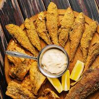 fried red mullet fish on wooden board photo