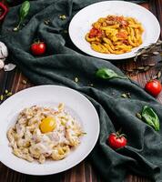 different types of italian pasta in bowls photo