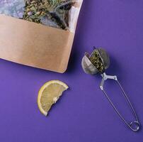 Dried and fresh tea leaves with lemon slice photo