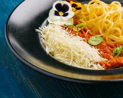Spaghetti with bolognese sauce and grated parmesan cheese photo
