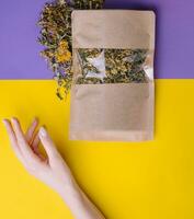 Paper bag with dry loose leaf tea photo