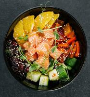 Poke bowl with salmon, cucumber, pepper and orange photo