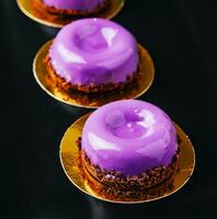 Mousse cakes from wild berries on plate photo