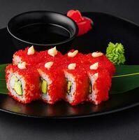 California Sushi roll cutting on black plate photo