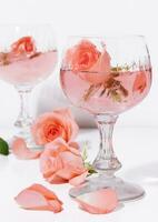 roses in pink champagne glasses with champagne bottle photo