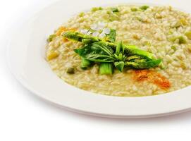 Dish of risotto with asparagus isolated on white plane photo