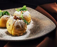 Baked apples stuffed with walnuts on plate photo