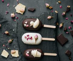 Top view of decorated cake pops ice creams on black background photo