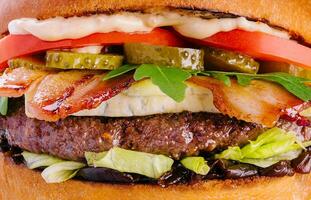 Bacon cheese burger with beef patty tomato cucumber photo