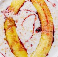 Oatmeal with fried banana close up or background photo