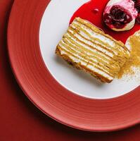 Napoleon cake with vanilla ice cream with cherry jam photo