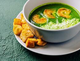 Broccoli green cream soup with shrimps photo