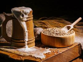 Wooden beer mug with beer and foam standing on a wooden table photo