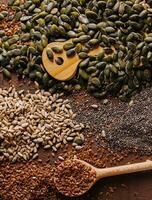 Different types of grains and seeds on shabby wooden photo