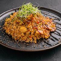 chinese fried rice with chicken on black plate photo