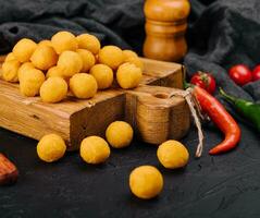 Tasty cheese balls on a wooden Board photo