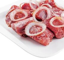 Raw pork meat with onions and spices for cooking kebabs photo