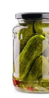 A glass jar of tasties canned cucumbers on white background photo