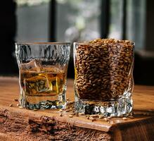 Glass of whiskey with ice and wheat photo