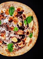 Tasty hot italian pizza for children with banana, chocolate and coconut photo