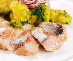 Salted fish with boiled potato and pickled onions photo