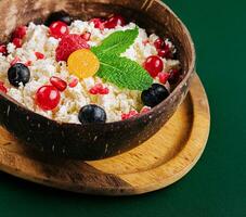 coconut bowl with cottage cheese and ripe berries photo