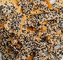 Salted tortilla chips triangle with chia seeds on top view photo