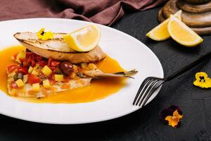 Tasty piece of bread with fried trout fillet photo