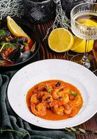 Shrimp in Romesco sauce and Mussels on wood photo