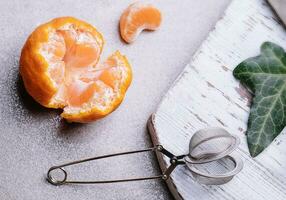 teapot with tangerines on top view photo