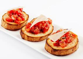 Traditional italian antipasto bruschetta appetizer with cherry tomatoes photo