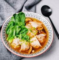 Soup gyoza, dumplings with bok-choy in clear soup photo