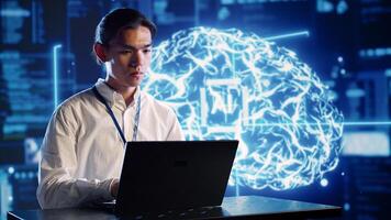 Organized engineer in high tech facility uses artificial intelligence computing simulating human brain. Dilligent admin doing operations on laptop with AI machine learning algorithms photo