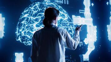 Experienced admin looking at hologram of artificial intelligence cognitive computing human brain simulation. Certified engineer interacting with AR AI visualization showing machine learning algorithms photo