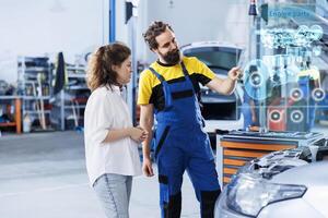 Technician in repair shop using augmented reality holograms to show client car performance parameters during maintenance. Trained garage employee using futuristic vr headset to examine damaged engine photo