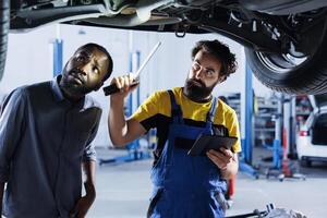 reparador en coche Servicio usos tableta a calcular factura después fijación roto automóvil ruedas profesional usos dispositivo a informar cliente de final costos después zurcidura vehículo suspendido en gastos generales foto