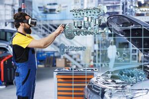 Mechanic in repair shop using augmented reality holograms to check car performance parameters during maintenance. Garage employee using futuristic vr headset to examine damaged vehicle photo