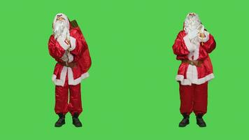 Papa Noel claus personaje Orando a Dios en estudio, vistiendo famoso rojo disfraz y blanco barba. padre Navidad orar a Jesús siendo espiritual y religioso, tradicional fiesta diciembre celebracion. foto