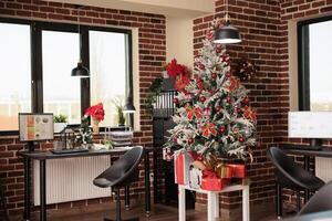 Analytics report on computer screen in modern office decorated with christmas tree and festive ornaments. Monitor with research statistics at workplace with no people during new year holiday photo
