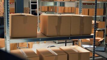 Empty storage room filled with many cardboard boxes on racks, empty warehouse with office space used to ship merchandise orders and do quality control. Storehouse with goods, logistics work. photo