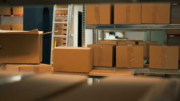 Empty storage space filled with stacks of merchandise and goods, shelves and racks of products in storehouse room. Warehouse used to deliver goods to customers working on logistics. photo