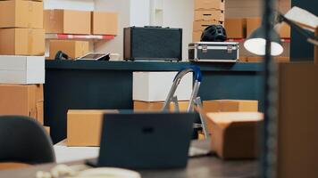 Warehouse room filled with goods and merchandise packages used for inventory and quality control, shipping products. Empty storehouse serving as small business space, shipment logistics. photo