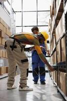African american package handlers scanning cardboard box bar code. All black storehouse workers team managing customer order picking and dispatching, using scanner on parcel photo