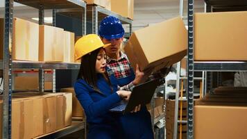 Asian employees checking stock goods on laptop, working with products on racks in storehouse depot. Team of people looking at inventory and merchandise logistics in storage room. photo