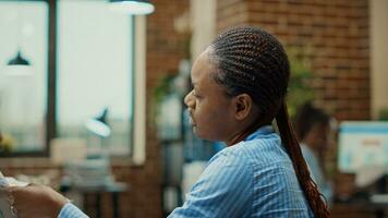 Startup team discussing new vision, checking annual data statistics to help with development strategy in office. Colleagues examining official information on documents for business presentation. photo