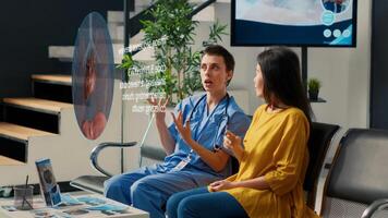 Cardiologist in modern clinic lounge using holographic projector, showing old patient heart close up scan, visualizing cardiology exam results using AR technology and teaching heart attack prevention photo