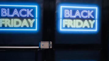 Empty clothing shop with labels for black friday event, stylish fashionable items and accessories at discounted prices. Clothing store decorated with glowing signs and banners. photo