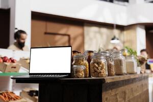 Mockup tablet with empty copy space used as advertising sign in ethically conscious zero waste supermarket. Isolated screen device in bulk products store acting as promotional message photo