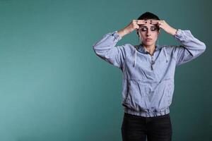 Frustrated nervous model putting hand on forehead trying not to scream after hearing the bad news during studio shot, posing over isolated background. Sad unhappy woman having displeased expression photo