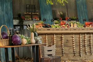 Autumn harvest on farmers market counter with wide variety of colorful organic fruits and vegetables, empty local market. Seasonal products farm produce stand with healthy natural food. photo